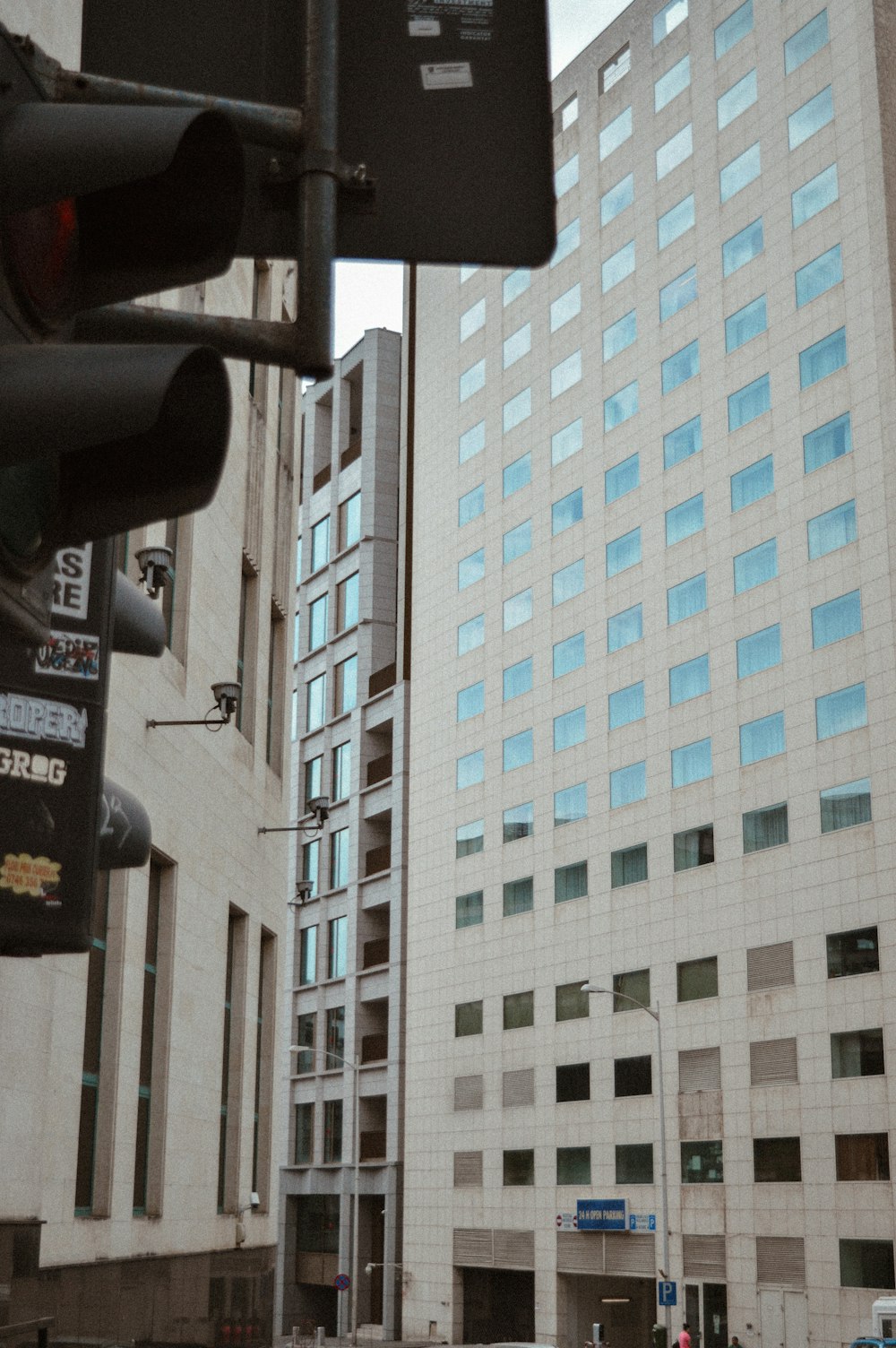 a traffic light sitting in front of a tall building