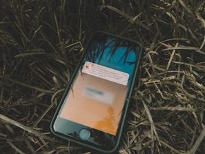 Close-up of a notification alert on a smartphone indicating a production issue