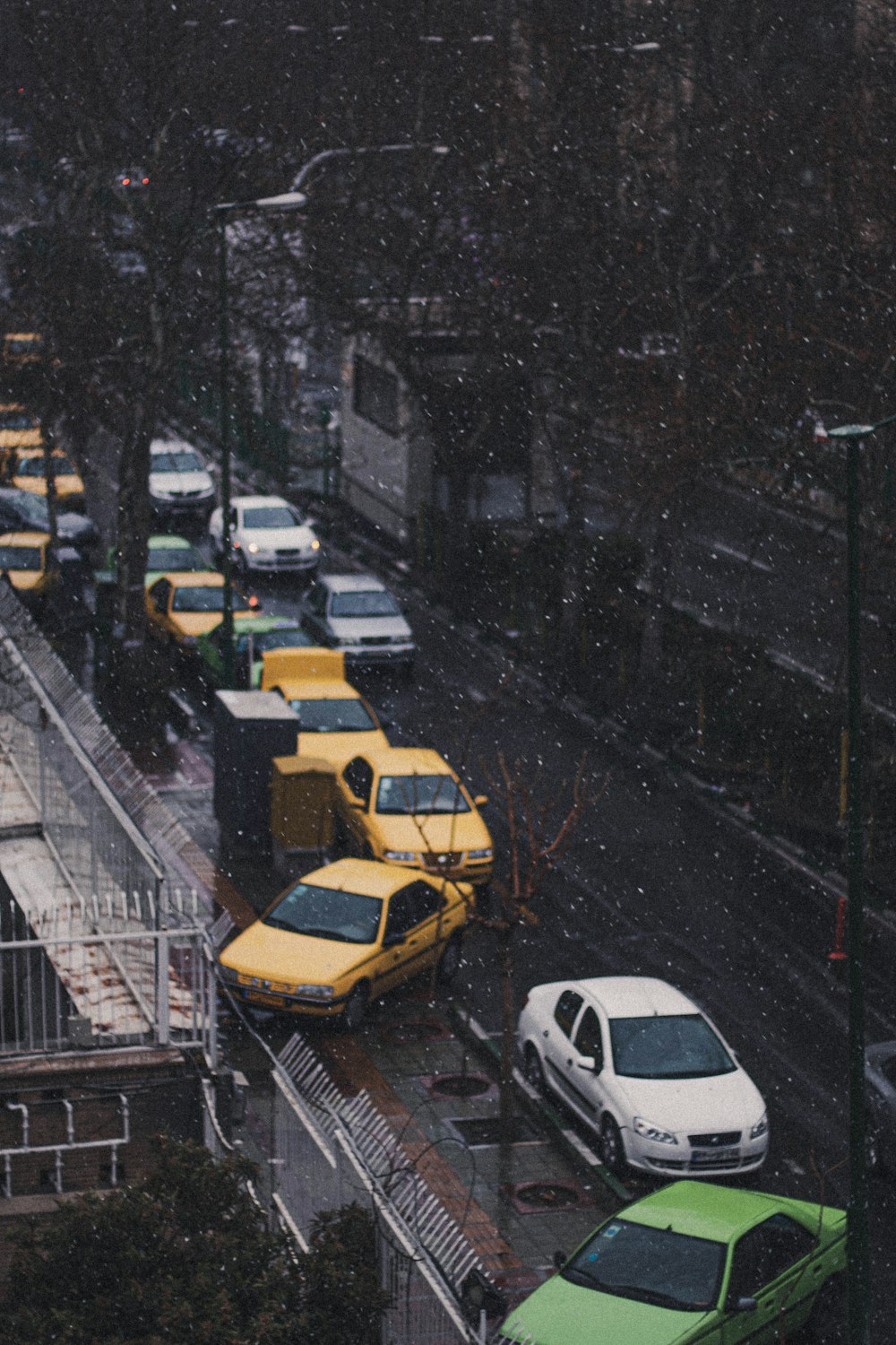 a street filled with lots of traffic next to tall buildings