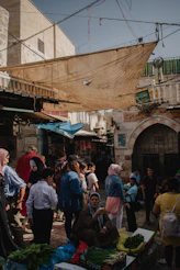 a group of people standing around a market
