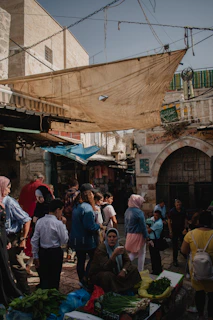 a group of people standing around a market