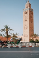 a horse drawn carriage in front of a tall tower