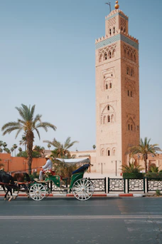 A horse-drawn carriage passing the Koutoubia Mosque in Marrakech, Morocco.