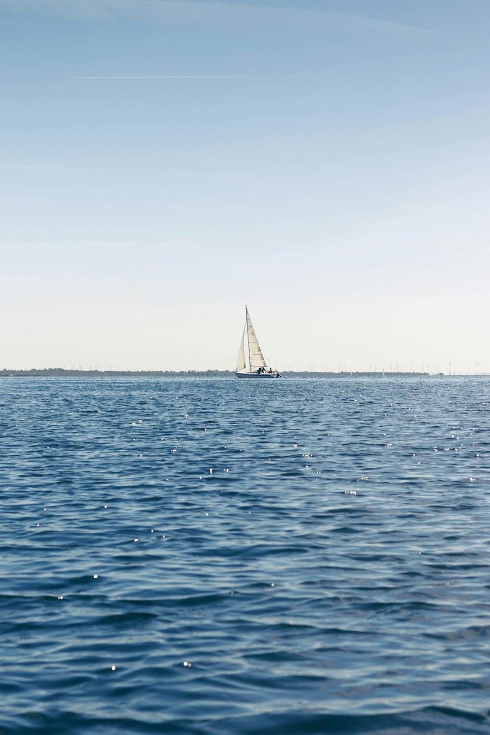 a sailboat sailing across a large body of water