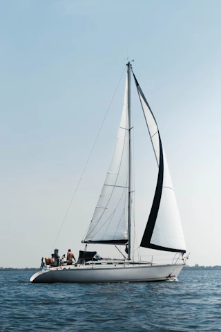 A group sailing on a calm Mediterranean sea under a clear blue sky.