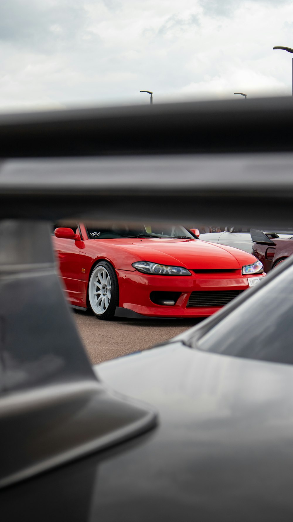 a red sports car parked in a parking lot