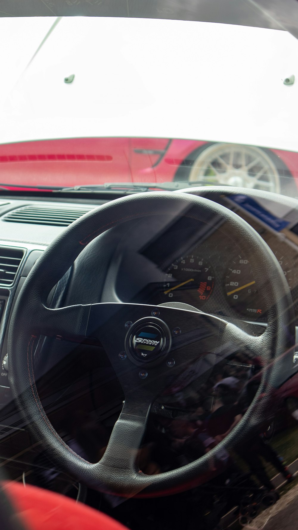 the interior of a car with a steering wheel and dashboard