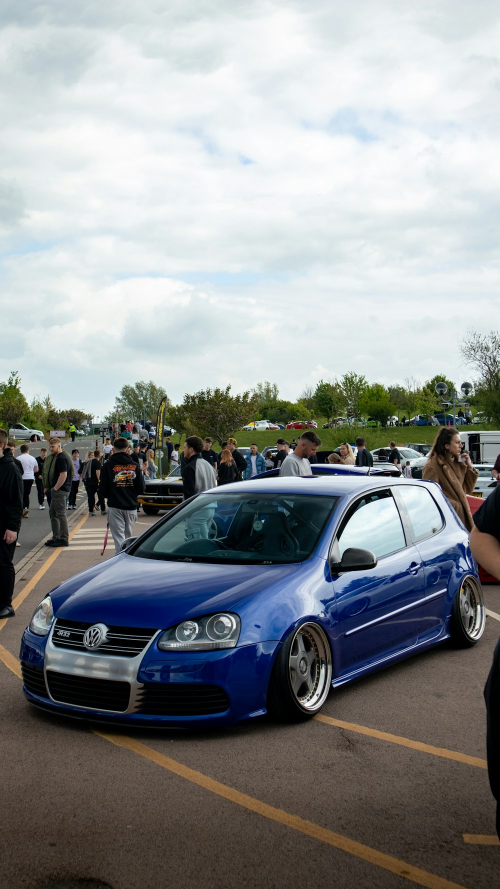 a blue car parked in a parking lot