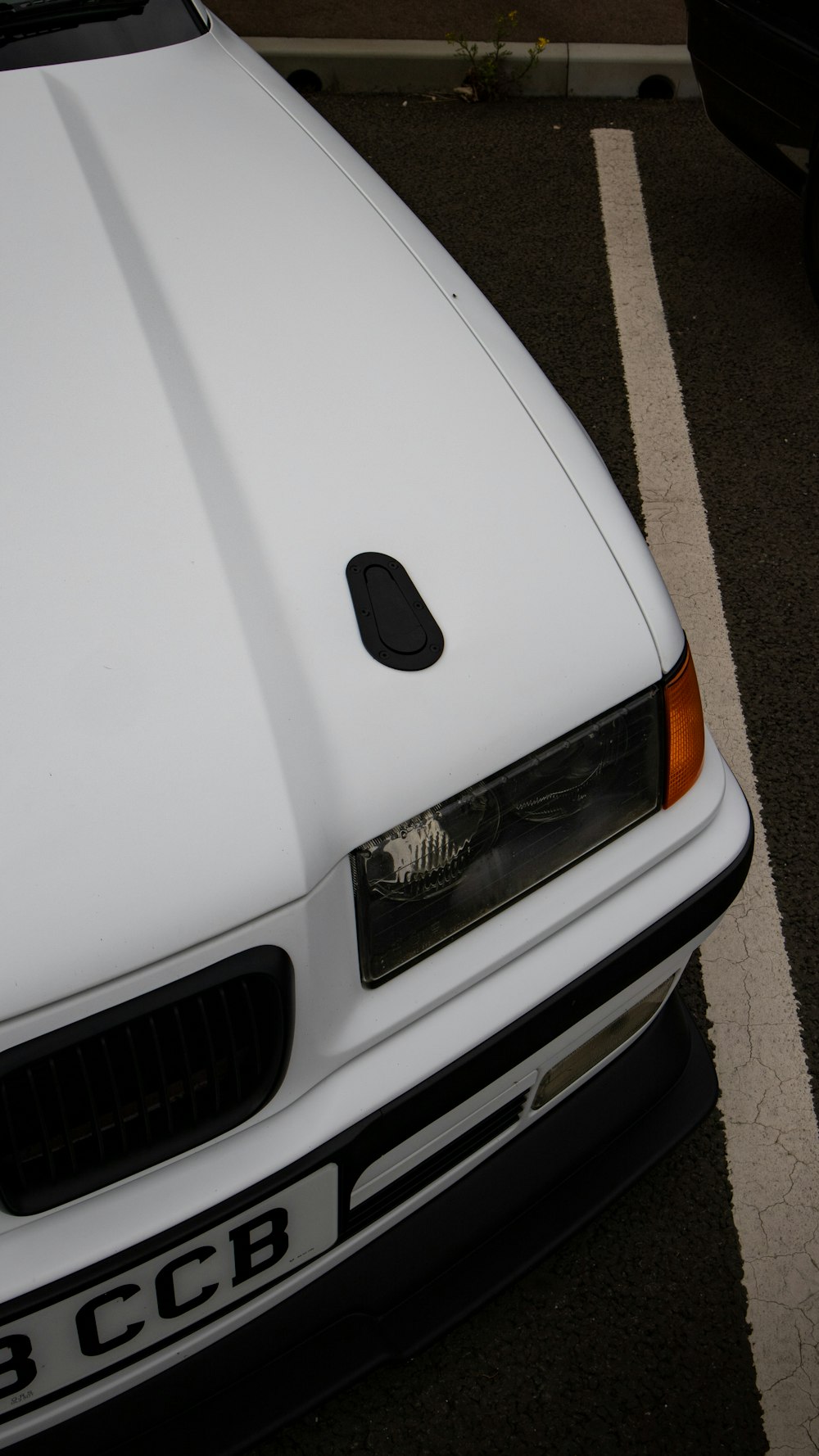 a white car parked in a parking lot