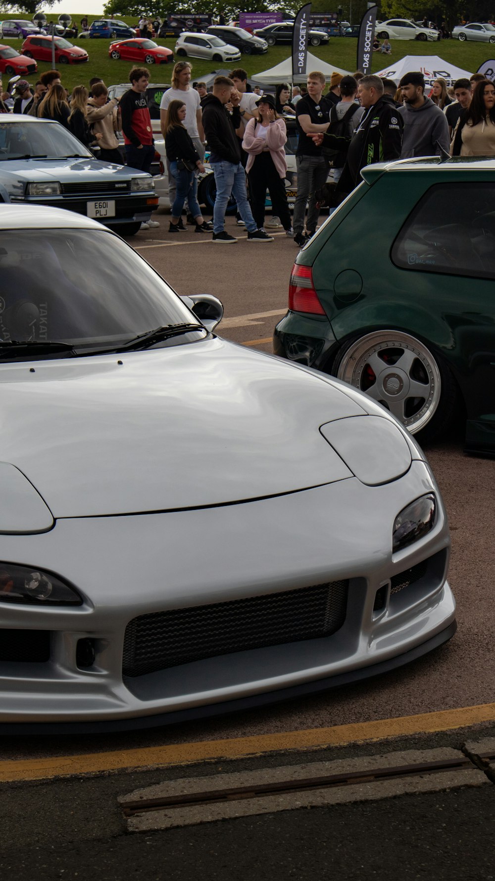 a white sports car parked in a parking lot