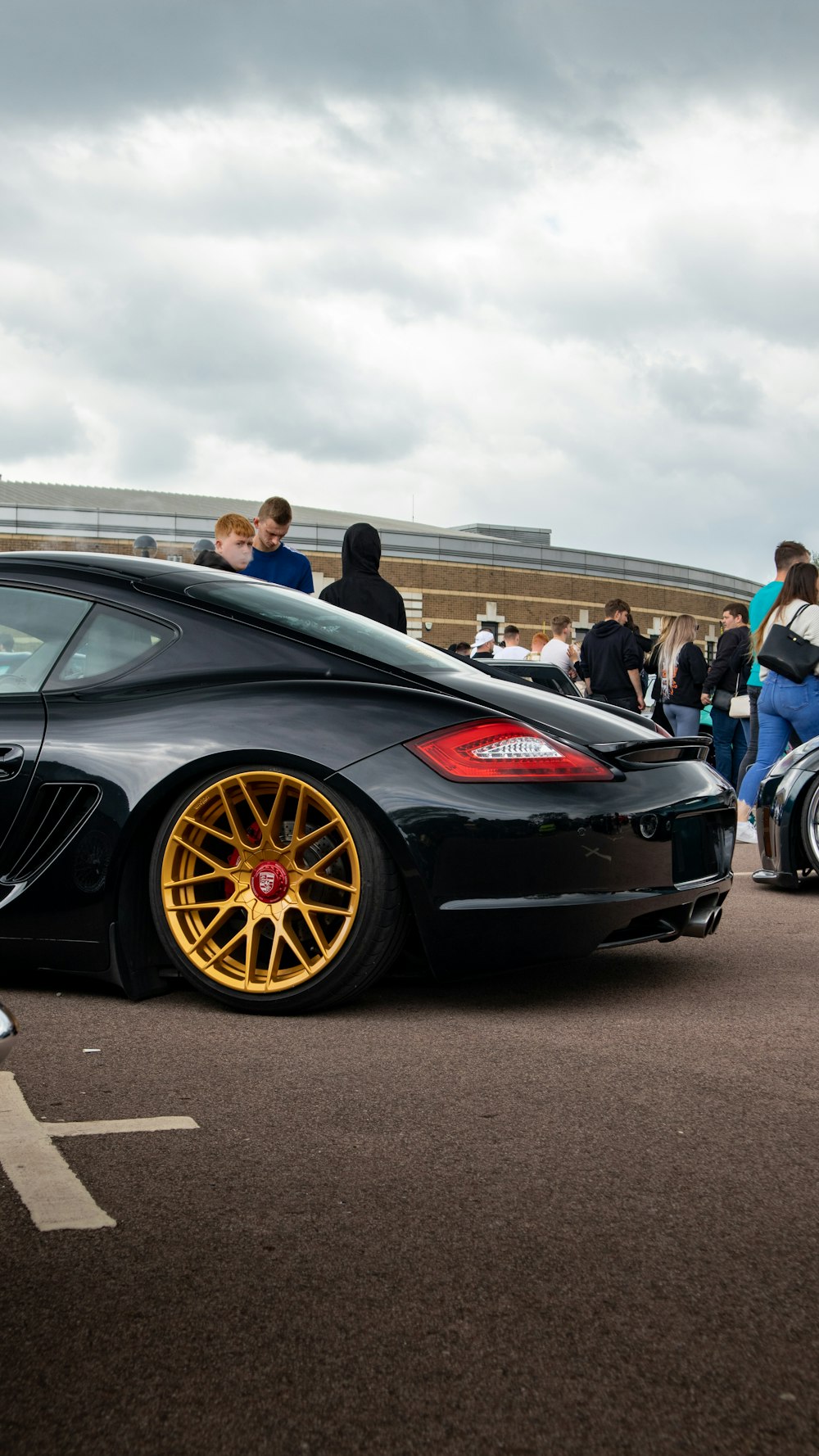 a black sports car parked in a parking lot