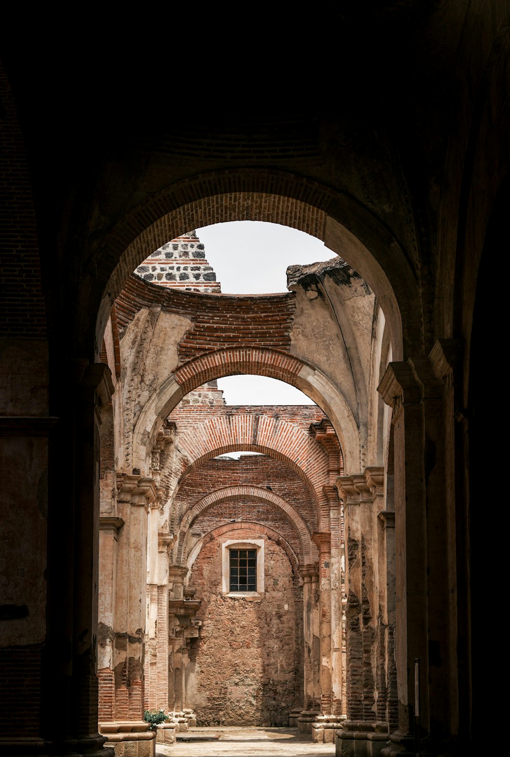 an archway in an old building with a clock on top