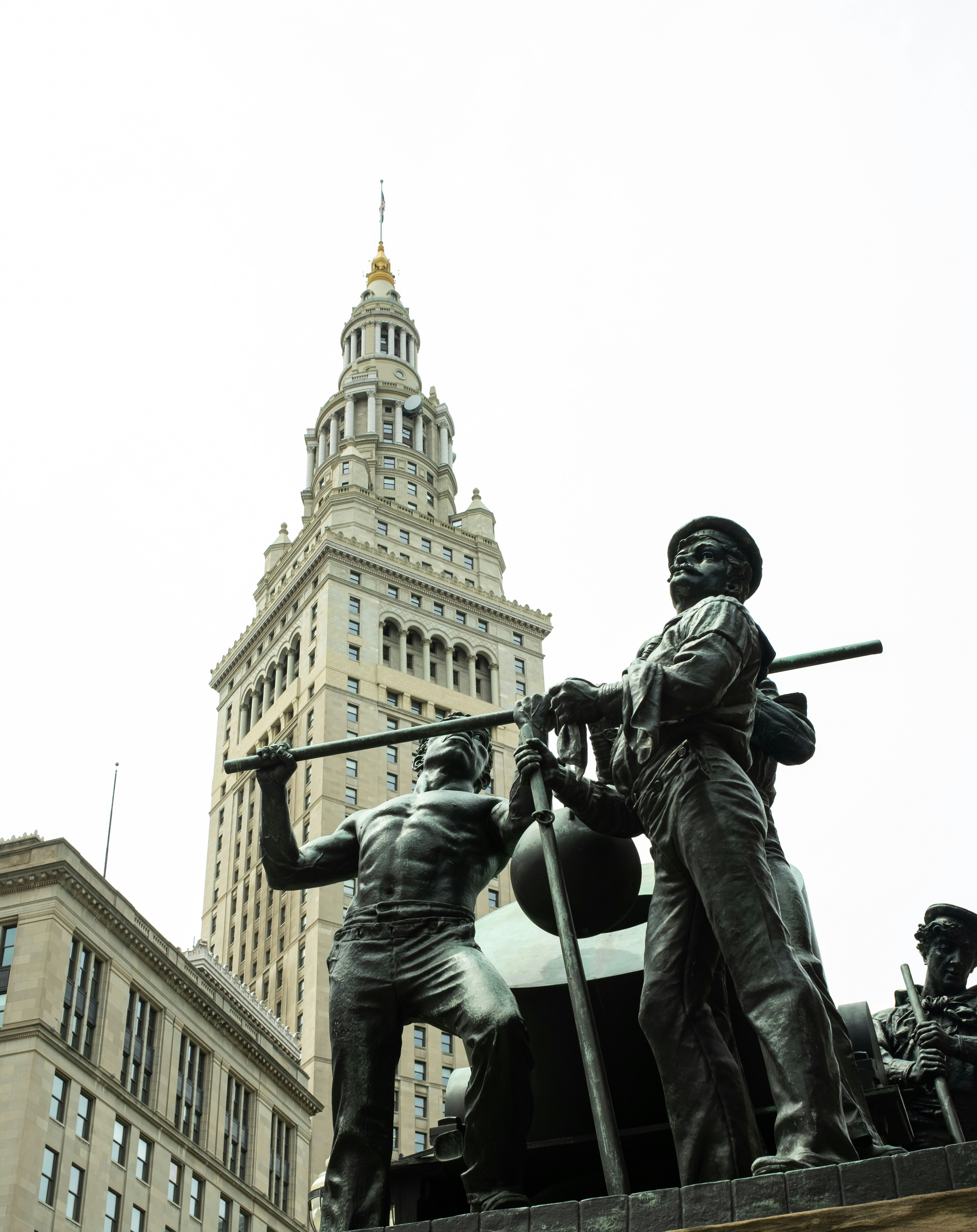 a statue of a man holding a gun next to a statue of a man with
