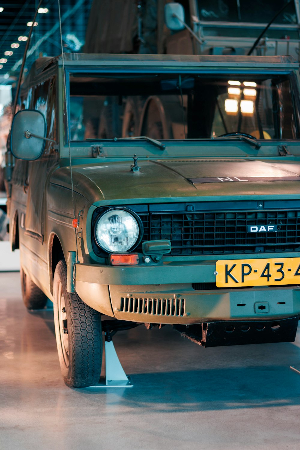 a green car is parked in a garage