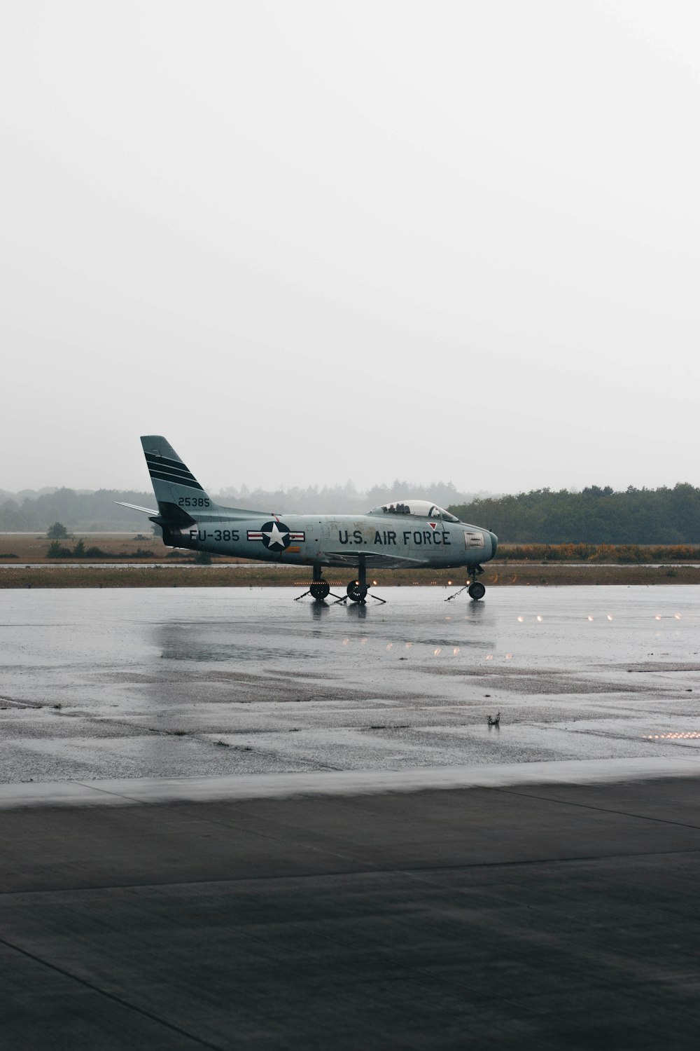 a large air force jet sitting on top of an airport runway