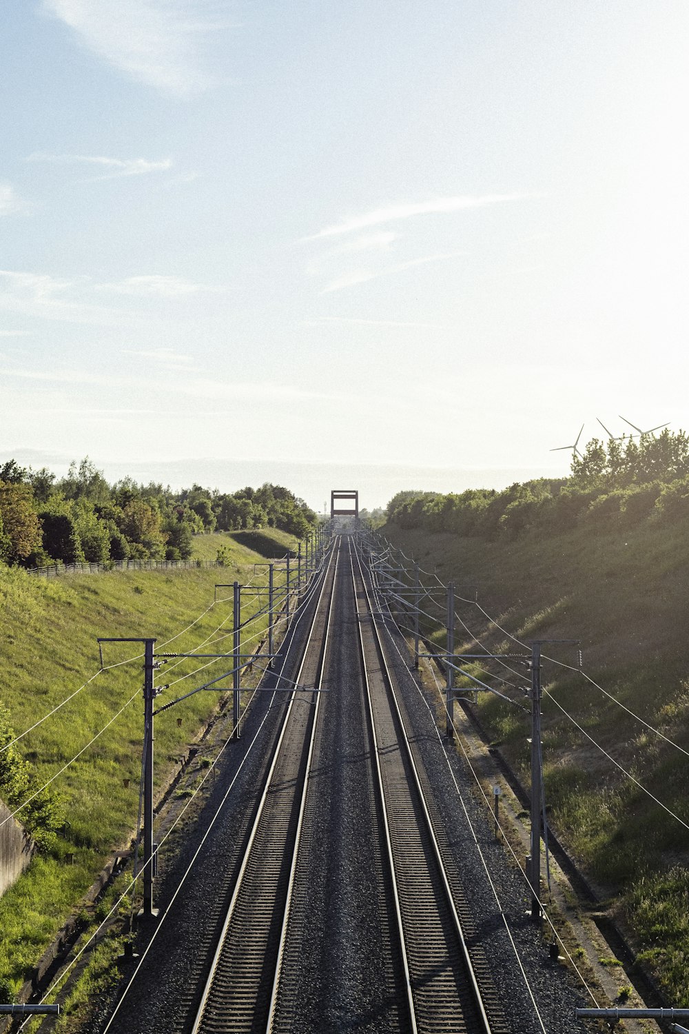 a train track running through a lush green countryside