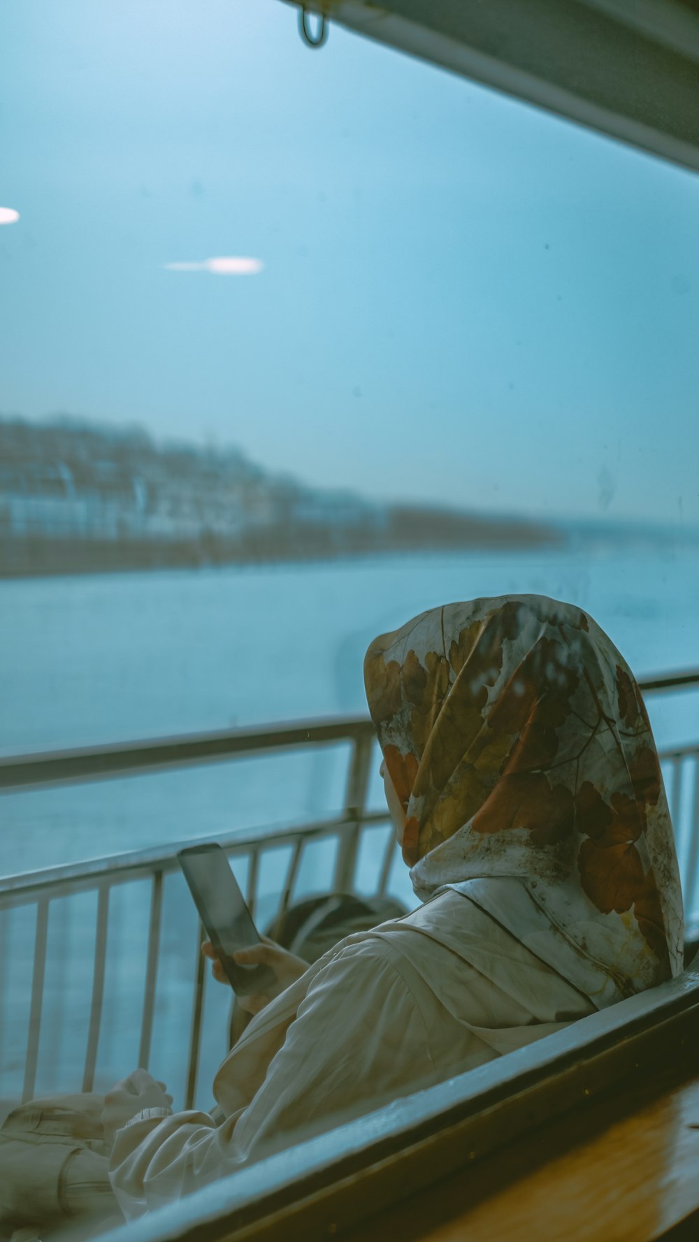 a person sitting on a train looking out the window