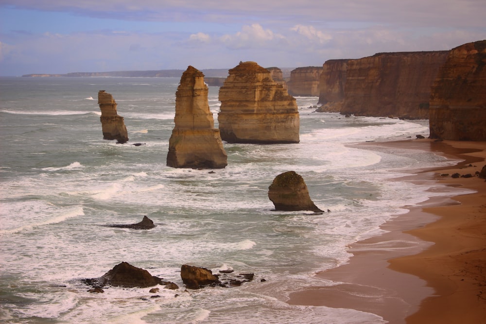 a view of a beach with a bunch of rocks in the water