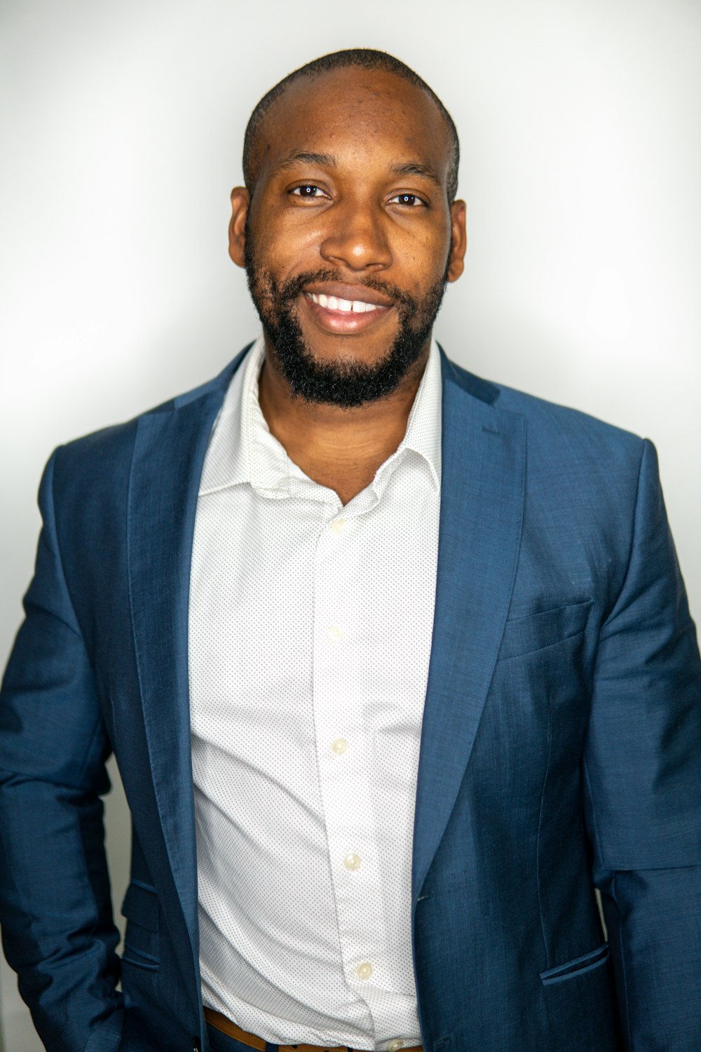 a man in a blue jacket and white shirt