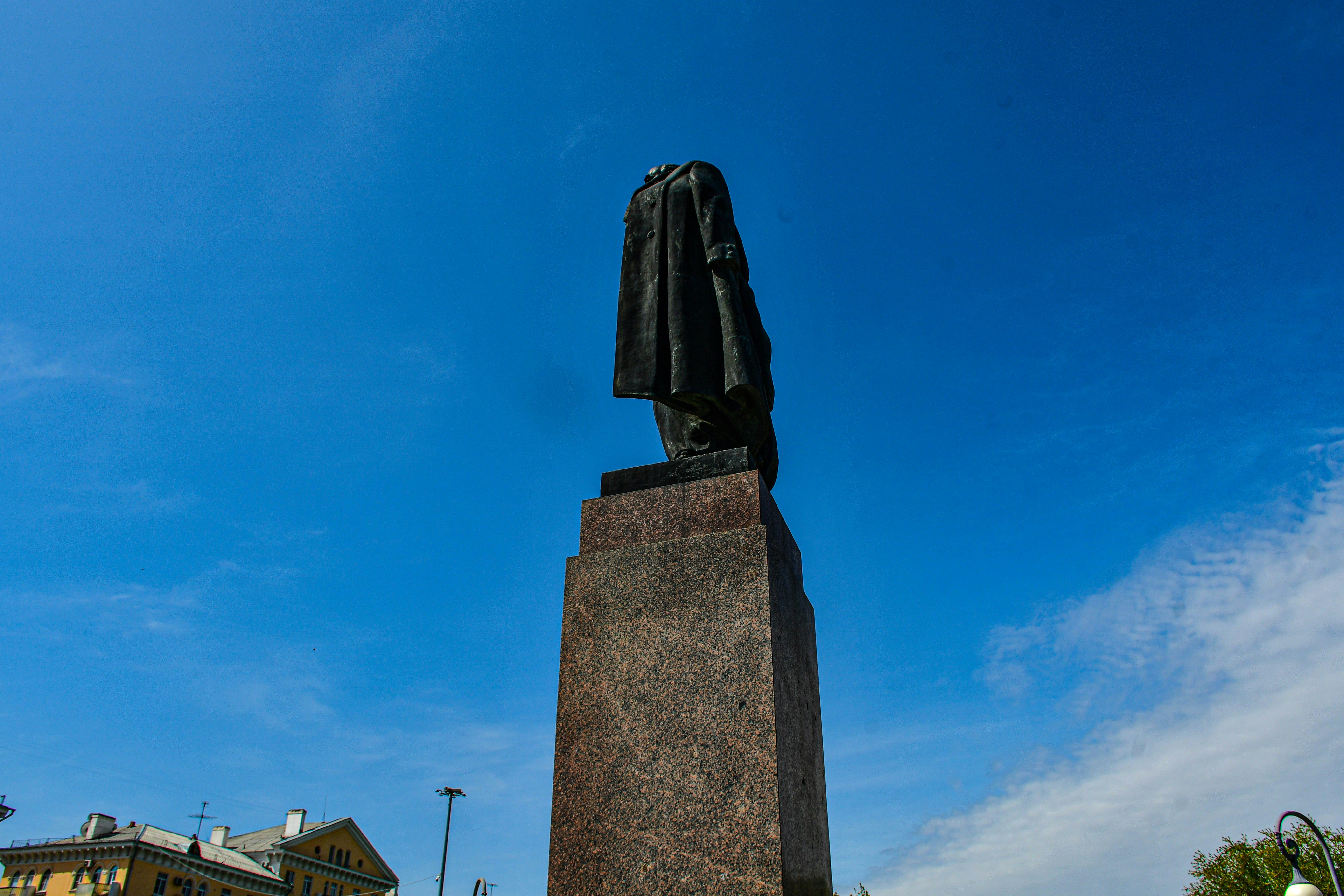 a statue of a man with a coat on top of it