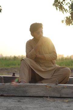 A thoughtful journalist interviewing a Kurdish elder in a sunlit village.
