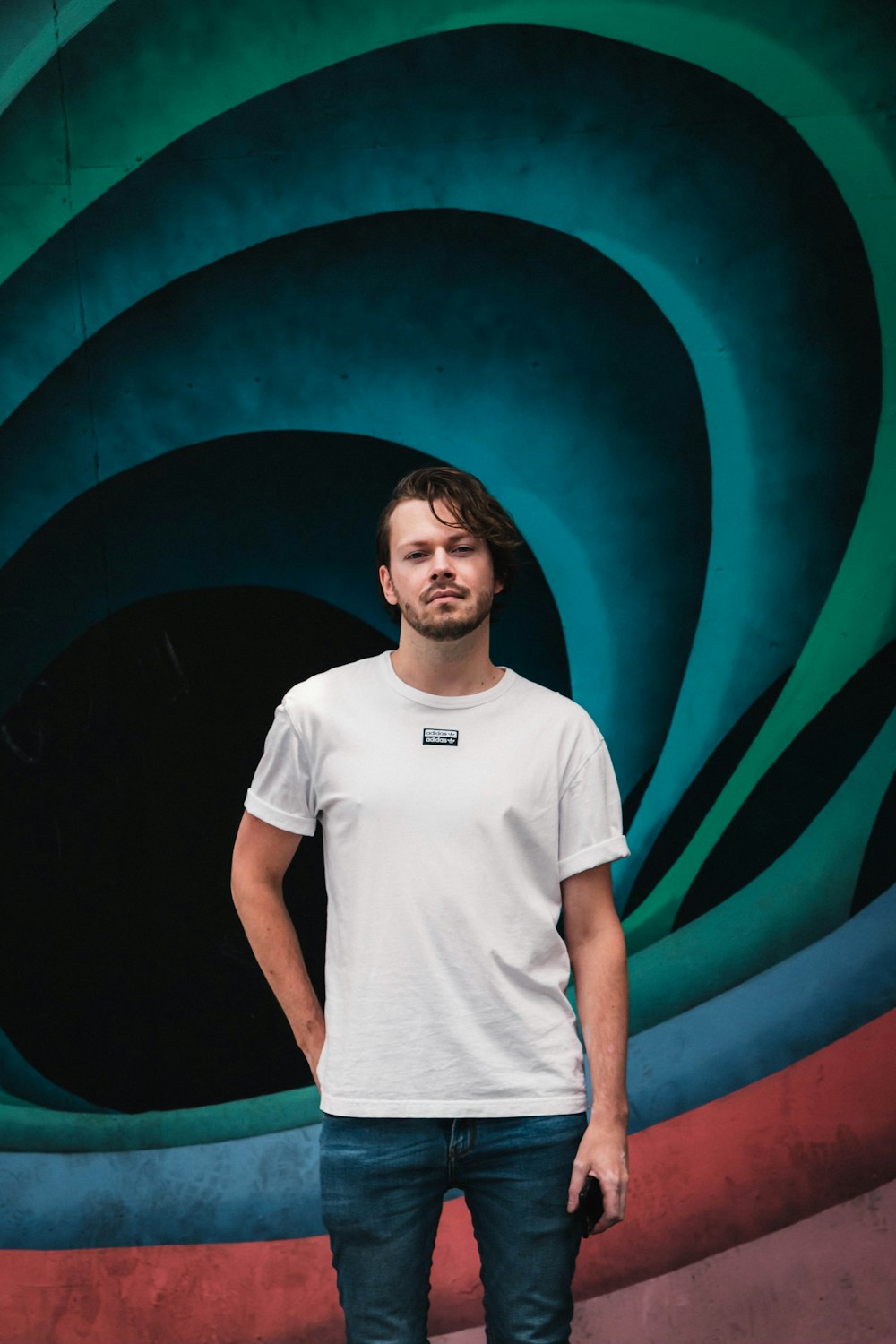 a man standing in front of a colorful wall