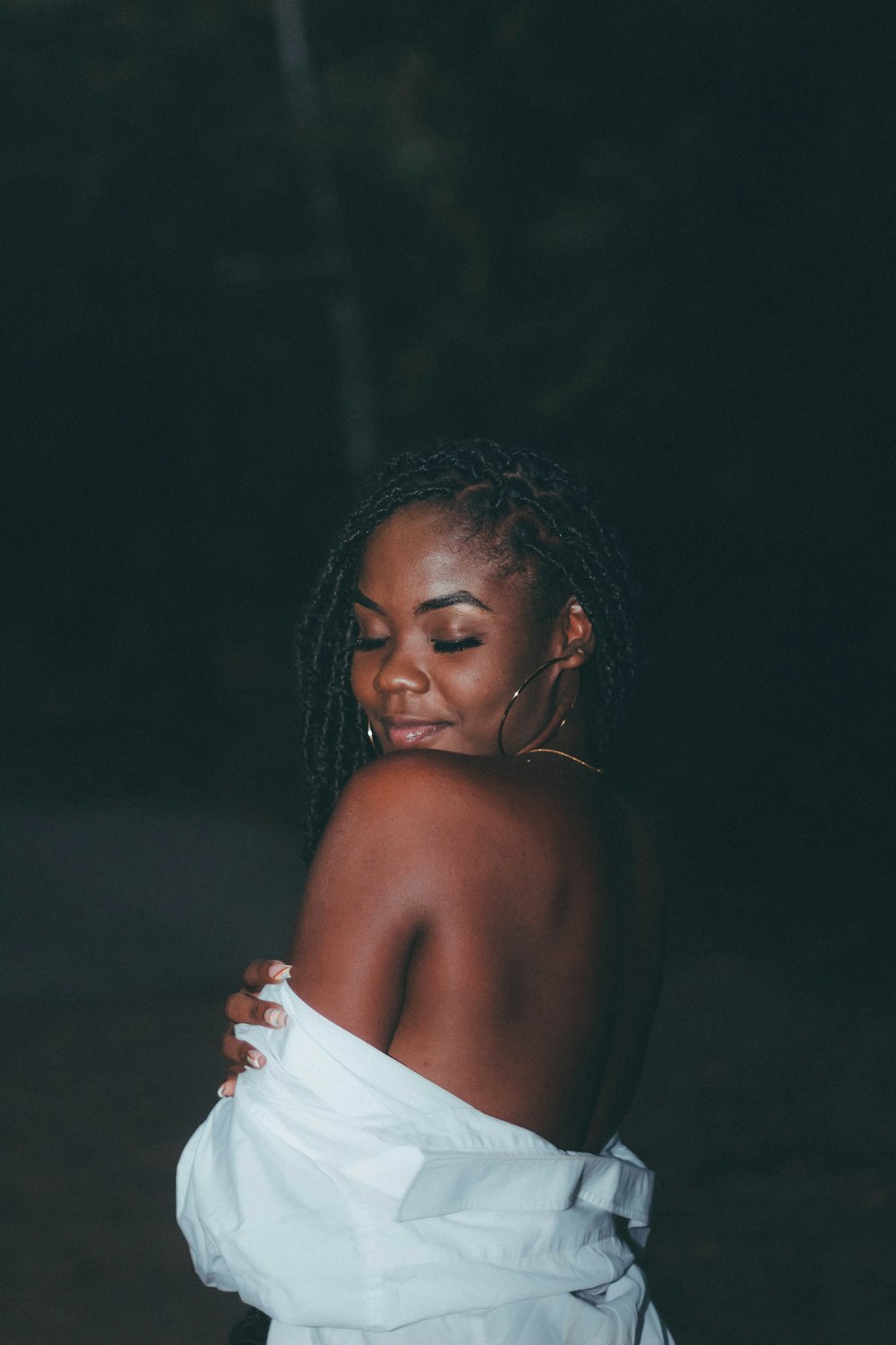 a woman with dreadlocks and a white dress