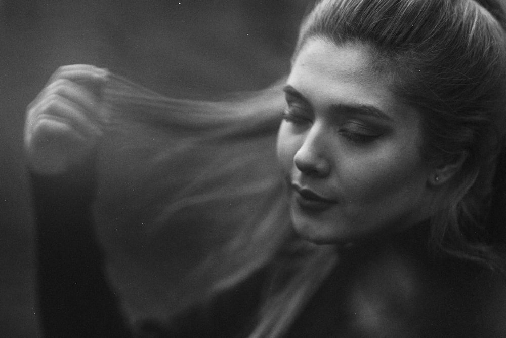 a woman with her hair blowing in the wind