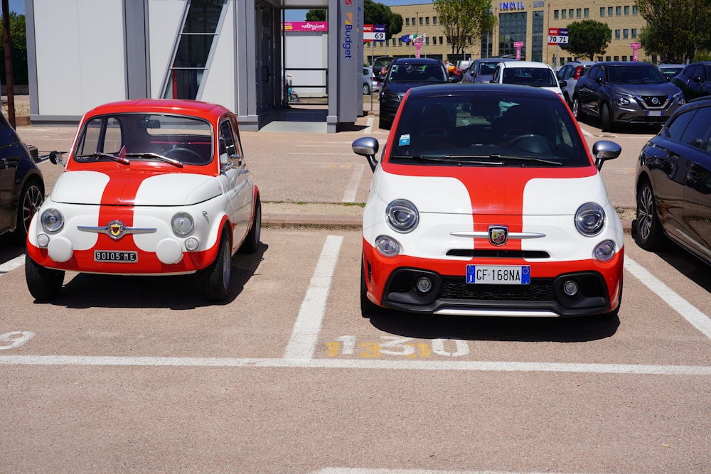 a couple of small cars parked in a parking lot