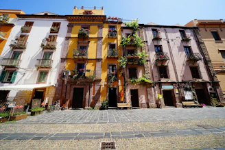 A charming street scene in a Balkan village with colorful houses and cobblestone paths.