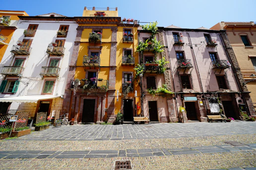 A traveler enjoying a scenic European street with colorful buildings and cobblestone paths.
