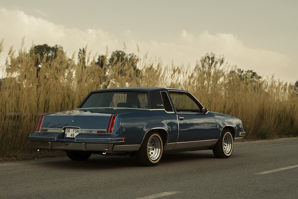 a blue car parked on the side of the road