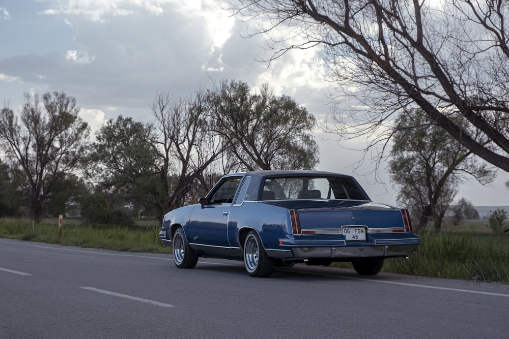 a blue car parked on the side of the road