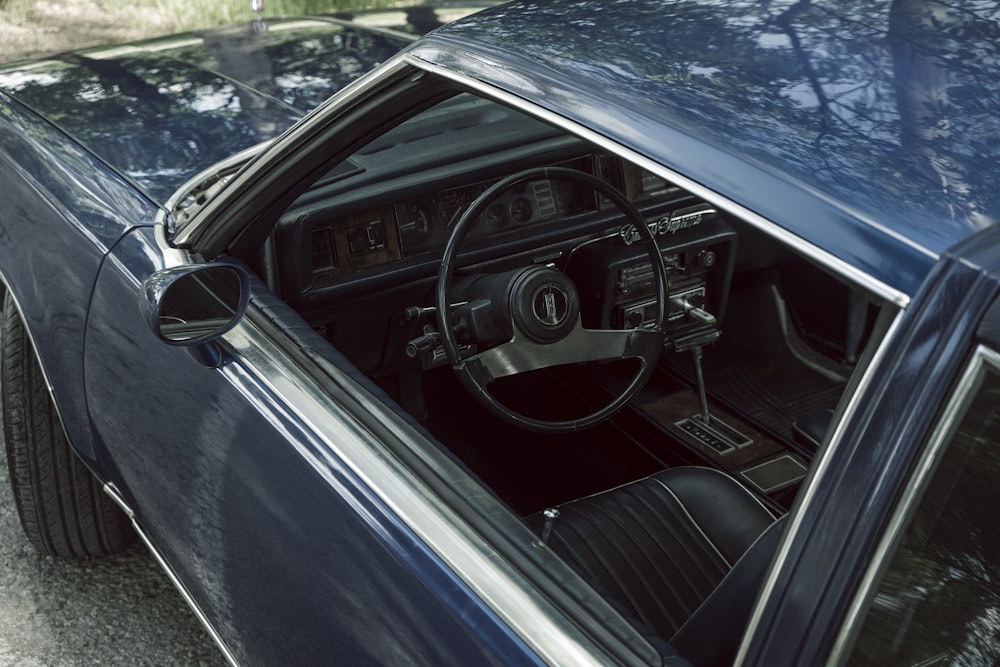 a blue car with a steering wheel and dashboard