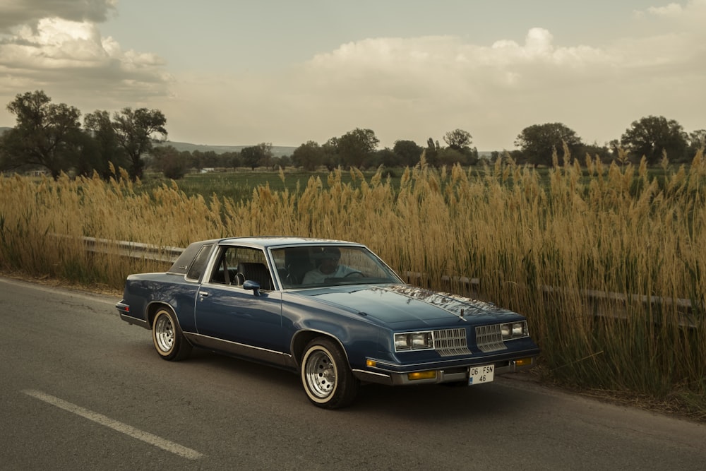 a blue car parked on the side of the road