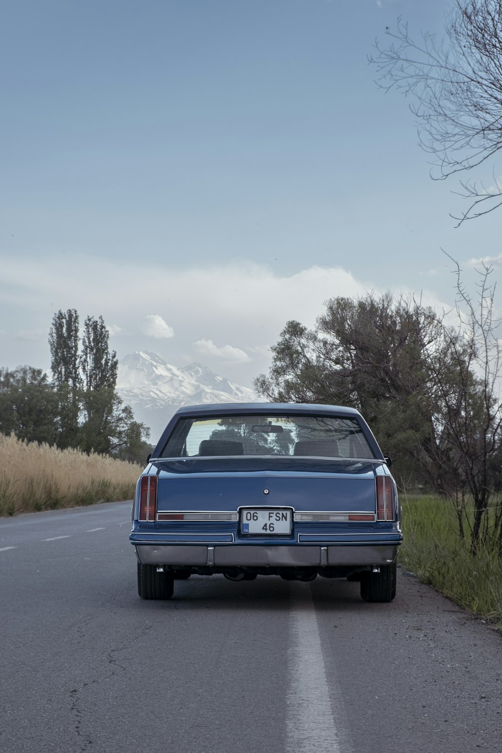 a blue car parked on the side of the road