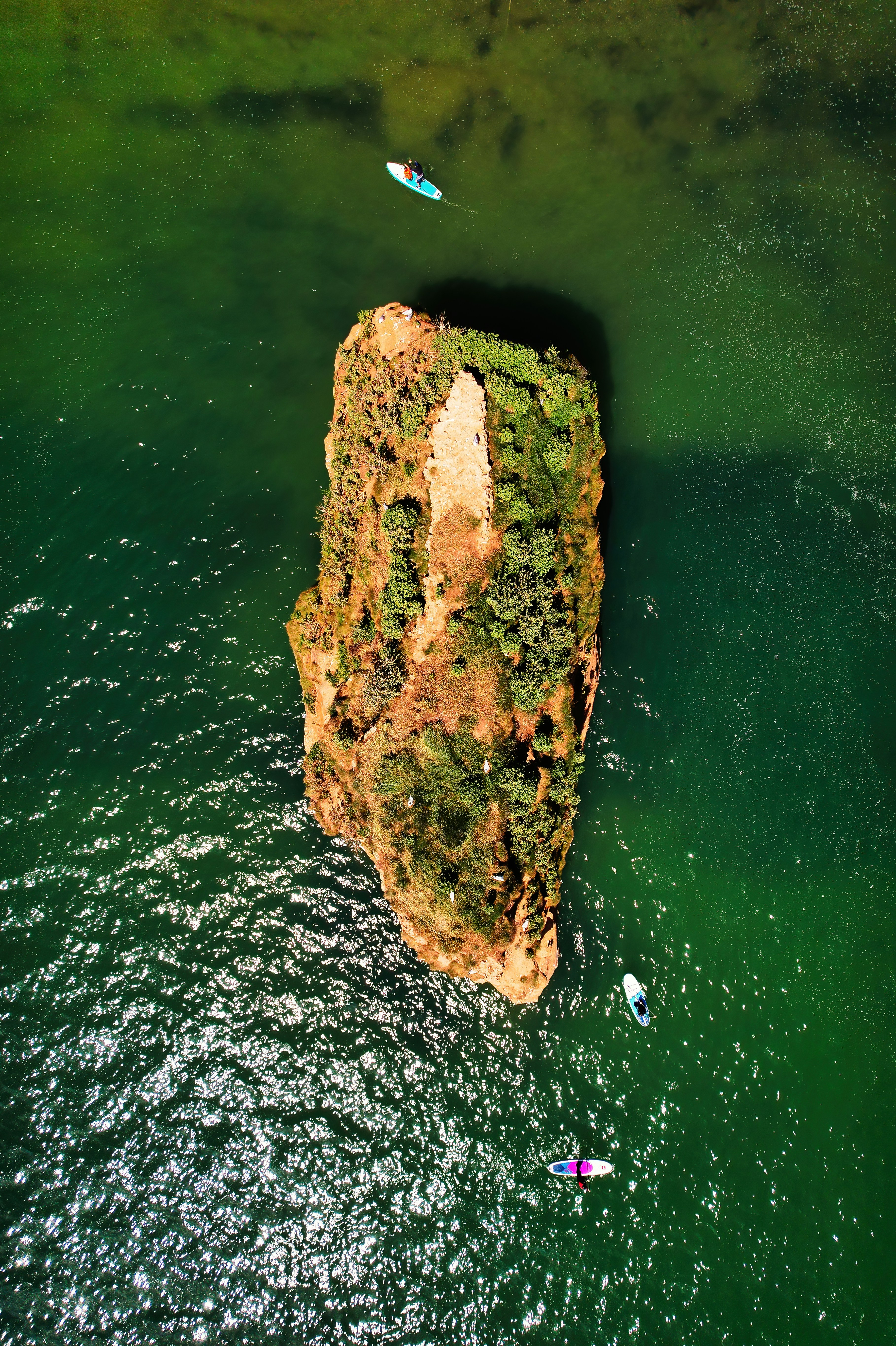 a large rock sticking out of the water