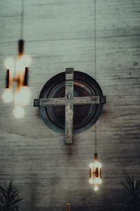 a cross hanging from the side of a wall