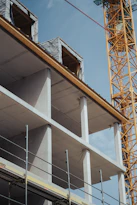 a building under construction with a crane in the background