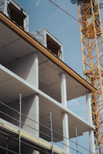 a building under construction with a crane in the background