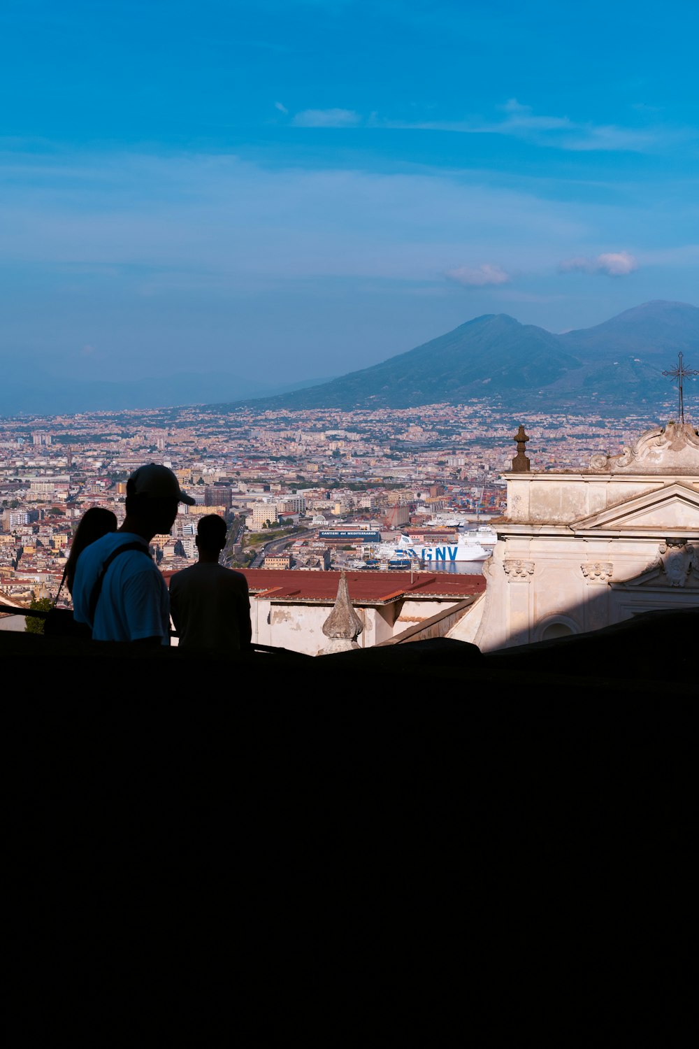 a couple of people standing on top of a hill