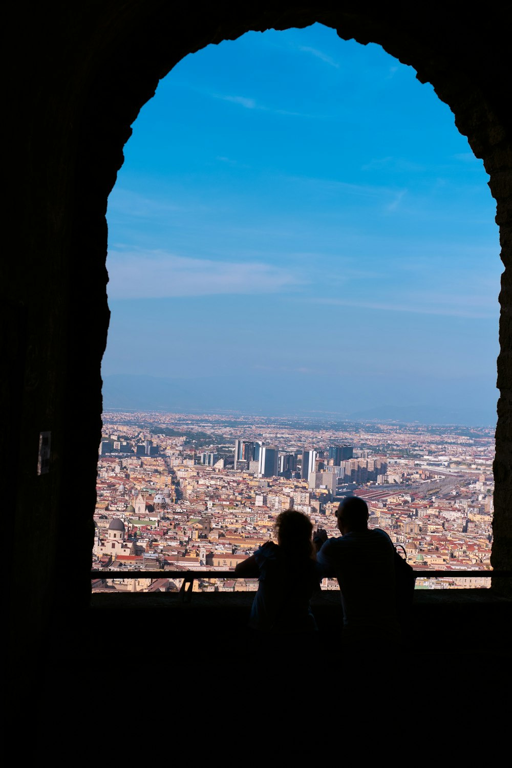 a couple of people sitting on top of a window sill