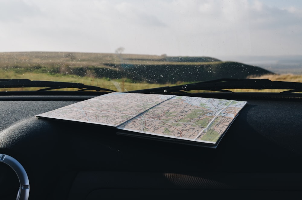 a map sitting on the dashboard of a car