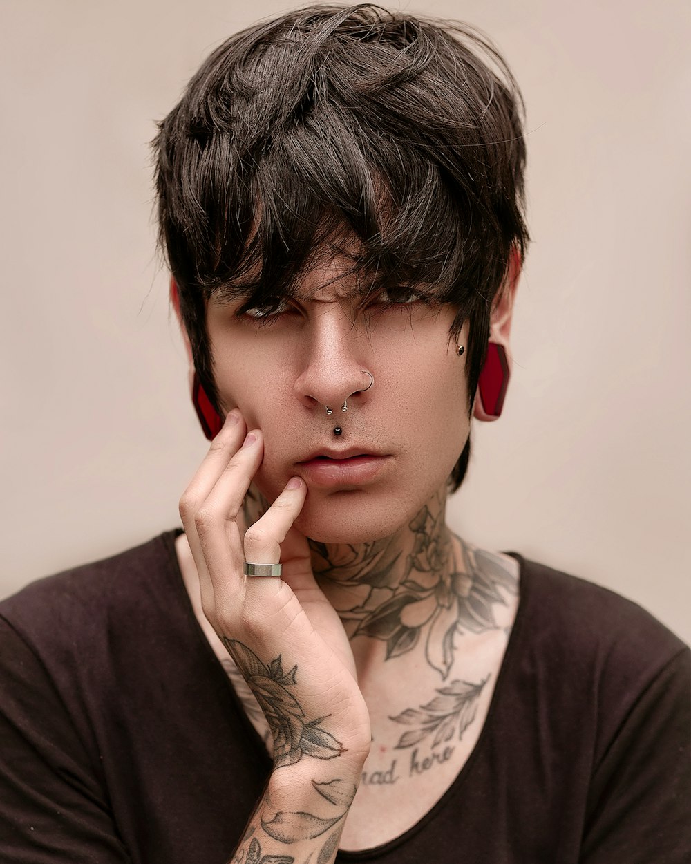 a man with tattoos on his neck and neck