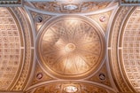 Close-up of a detailed ceiling design featuring gold accents and smooth finishes.