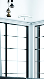 A modern apartment interior featuring a spacious living room and large windows.