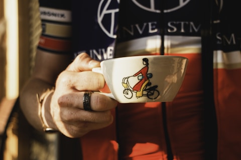 a person holding a coffee cup in their hand