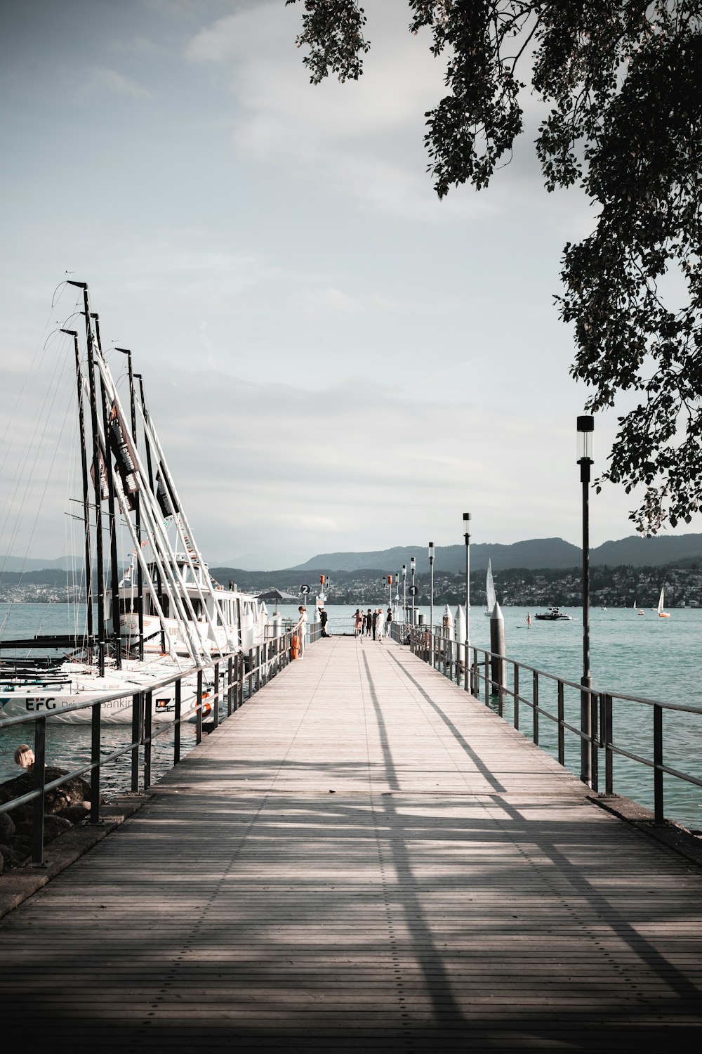 a long pier with a boat in the water