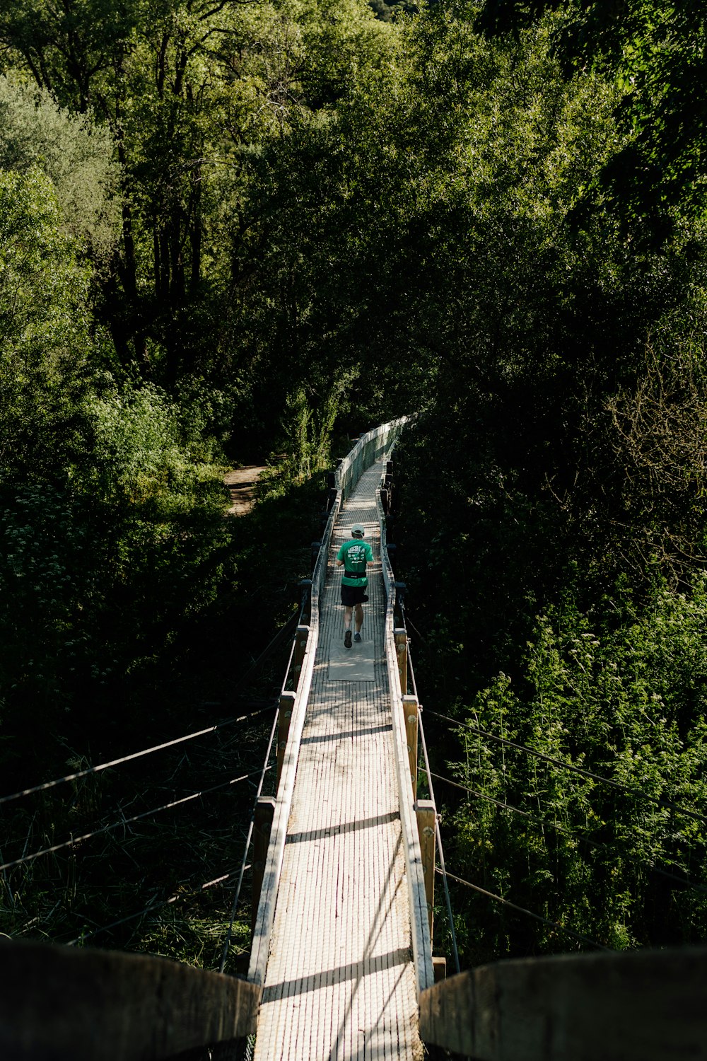 a person riding a bike across a bridge