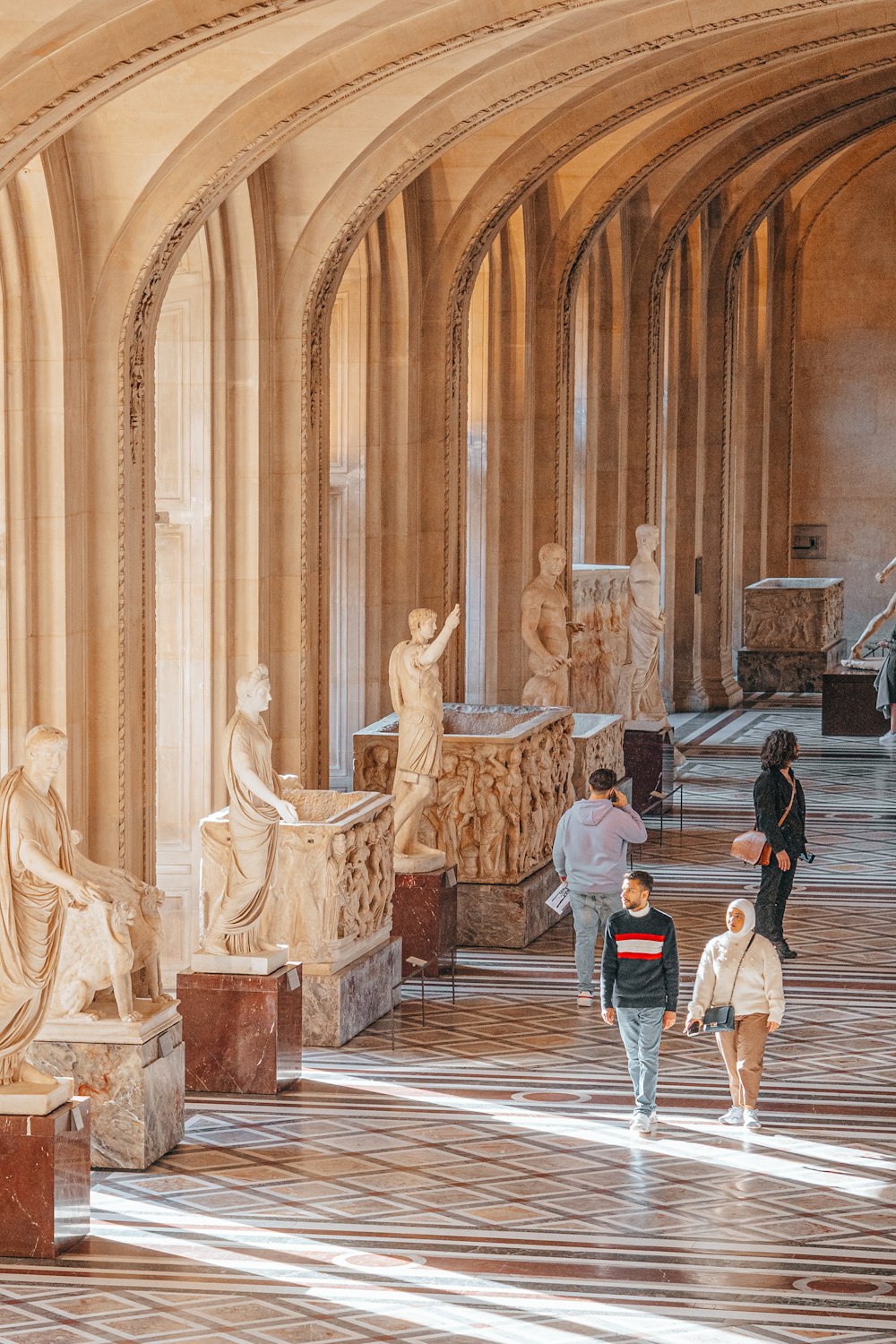 a group of people walking around a museum